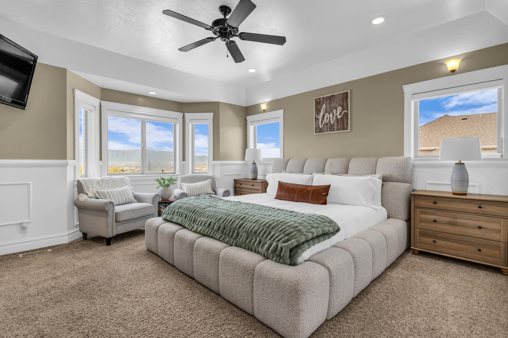 Spacious room featuring a tray ceiling, recessed lighting, and a ceiling fan