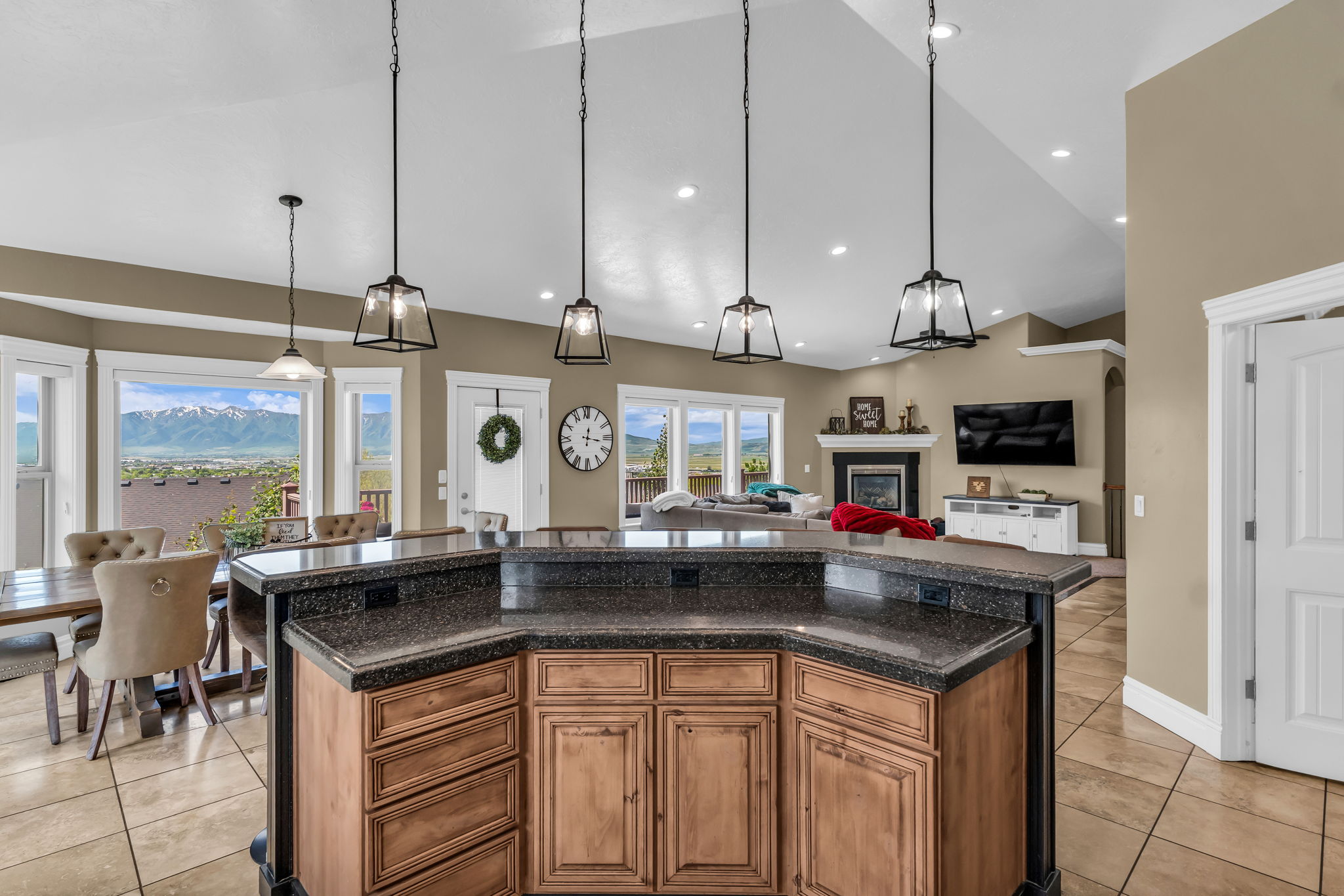 Kitchen island featuring wood cabinetry and dark stone countertops