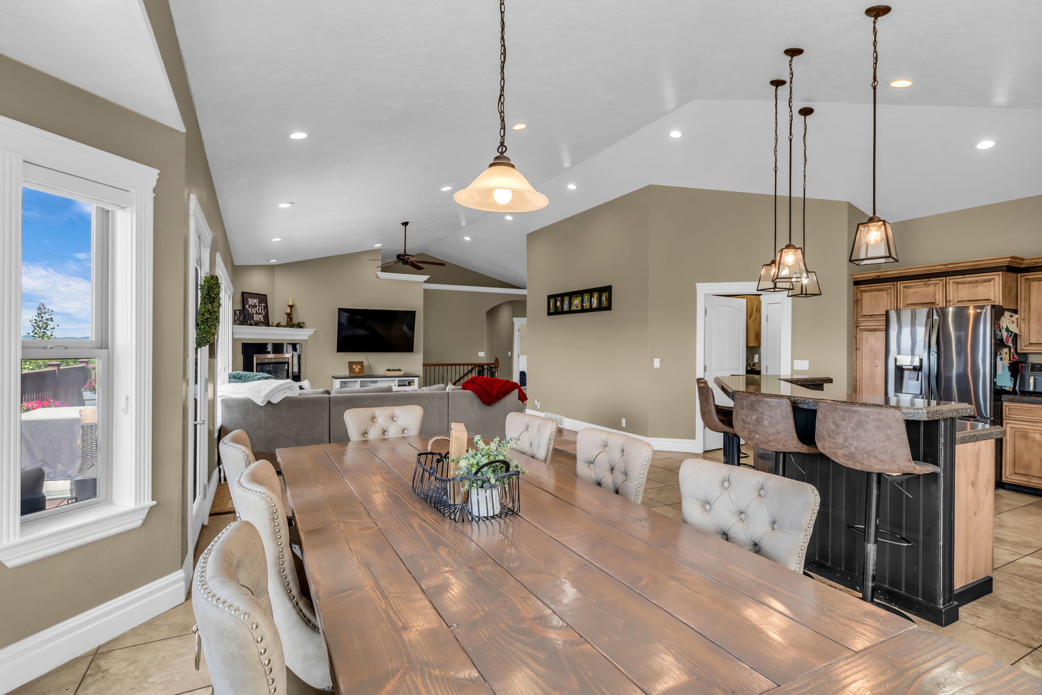 Spacious open-concept living area featuring a vaulted ceiling and recessed lighting