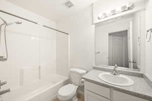 Bathroom with a white bathtub and shower combination featuring subway tile surround
