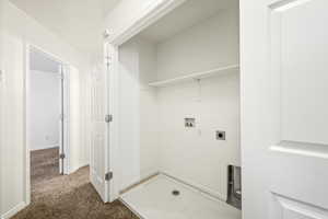 Dedicated laundry area with utility hookups and a utility pan, featuring an overhead shelf and bright white walls