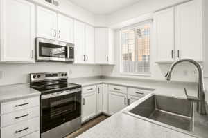Modern kitchen with white cabinetry and dark hardware