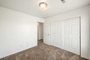 Room featuring light brown carpet, white walls, and white trim