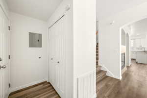 Entryway featuring wood-finish flooring, a bi-fold closet, and a staircase with carpeted treads