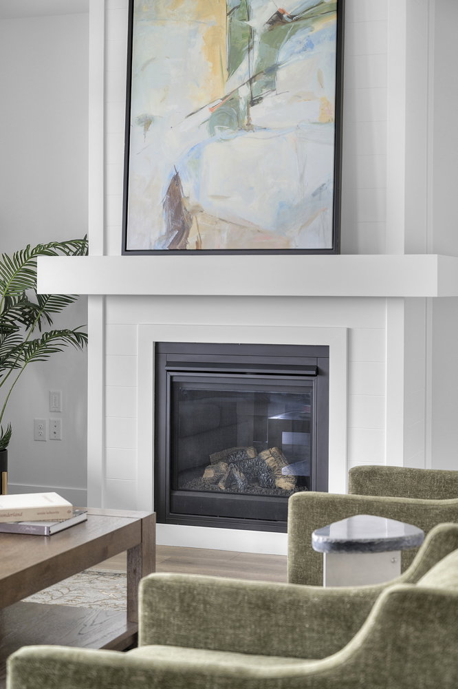 White fireplace with a black framed insert