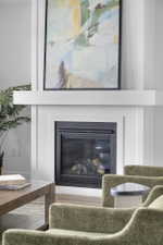 White fireplace with a black framed insert