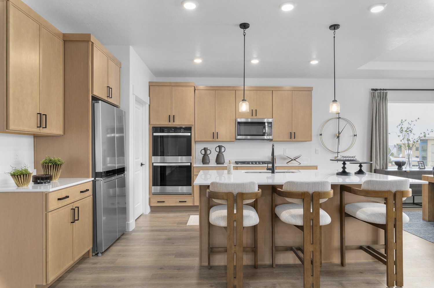 Modern kitchen featuring light wood-finish cabinetry and stainless steel appliances