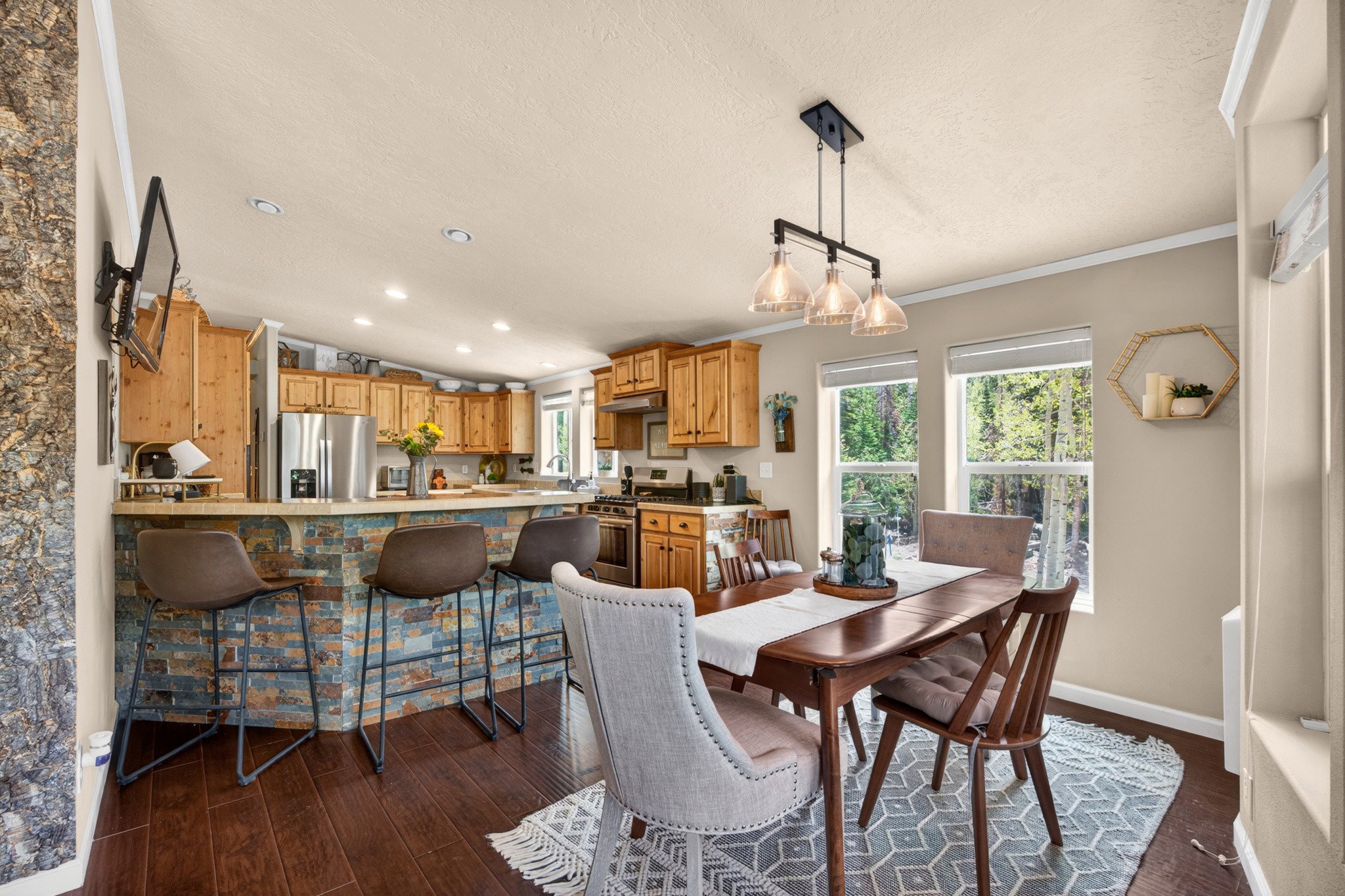 Open-concept kitchen and dining area featuring wood-finish flooring