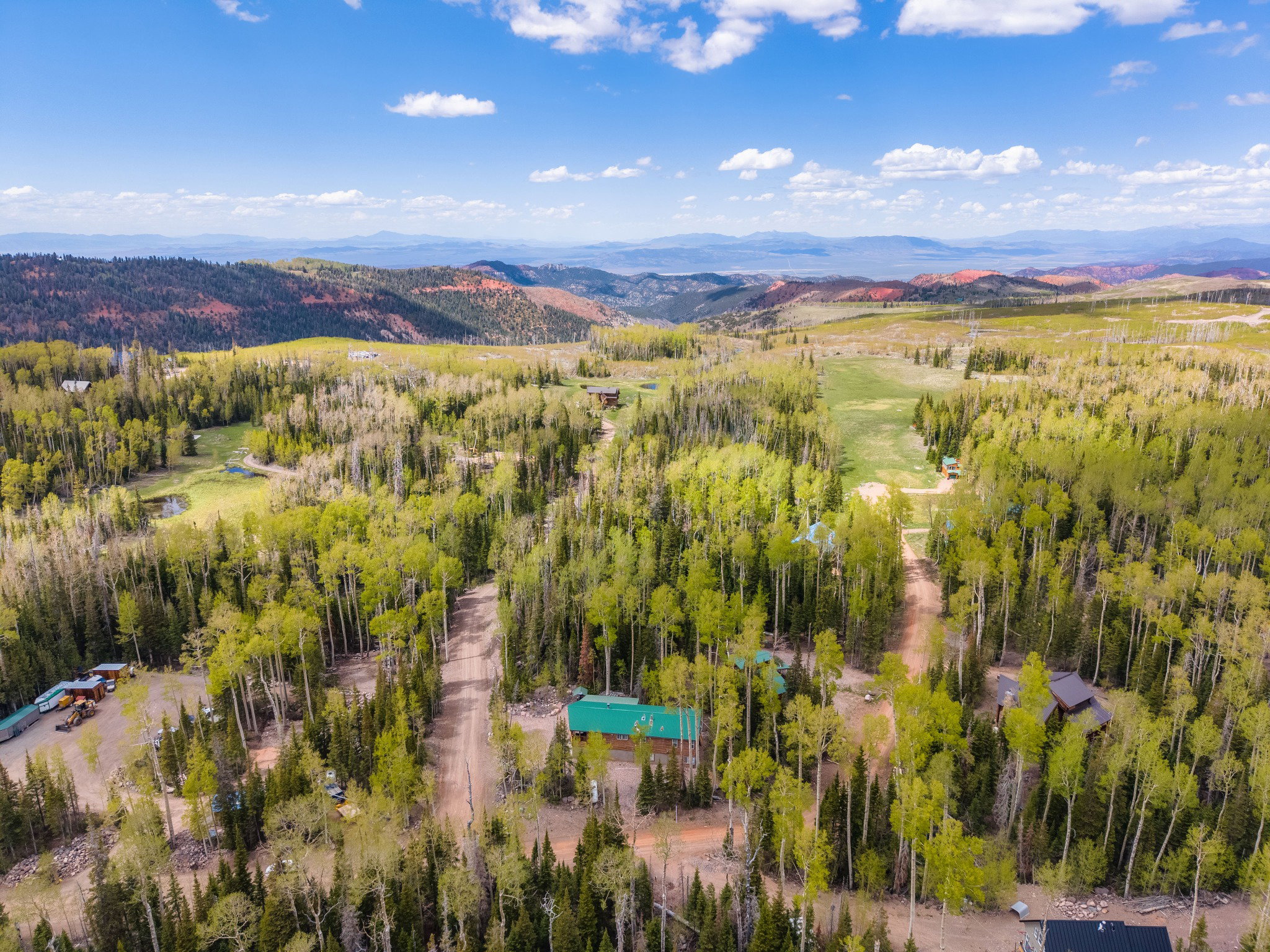 Expansive wooded terrain with scattered residential structures