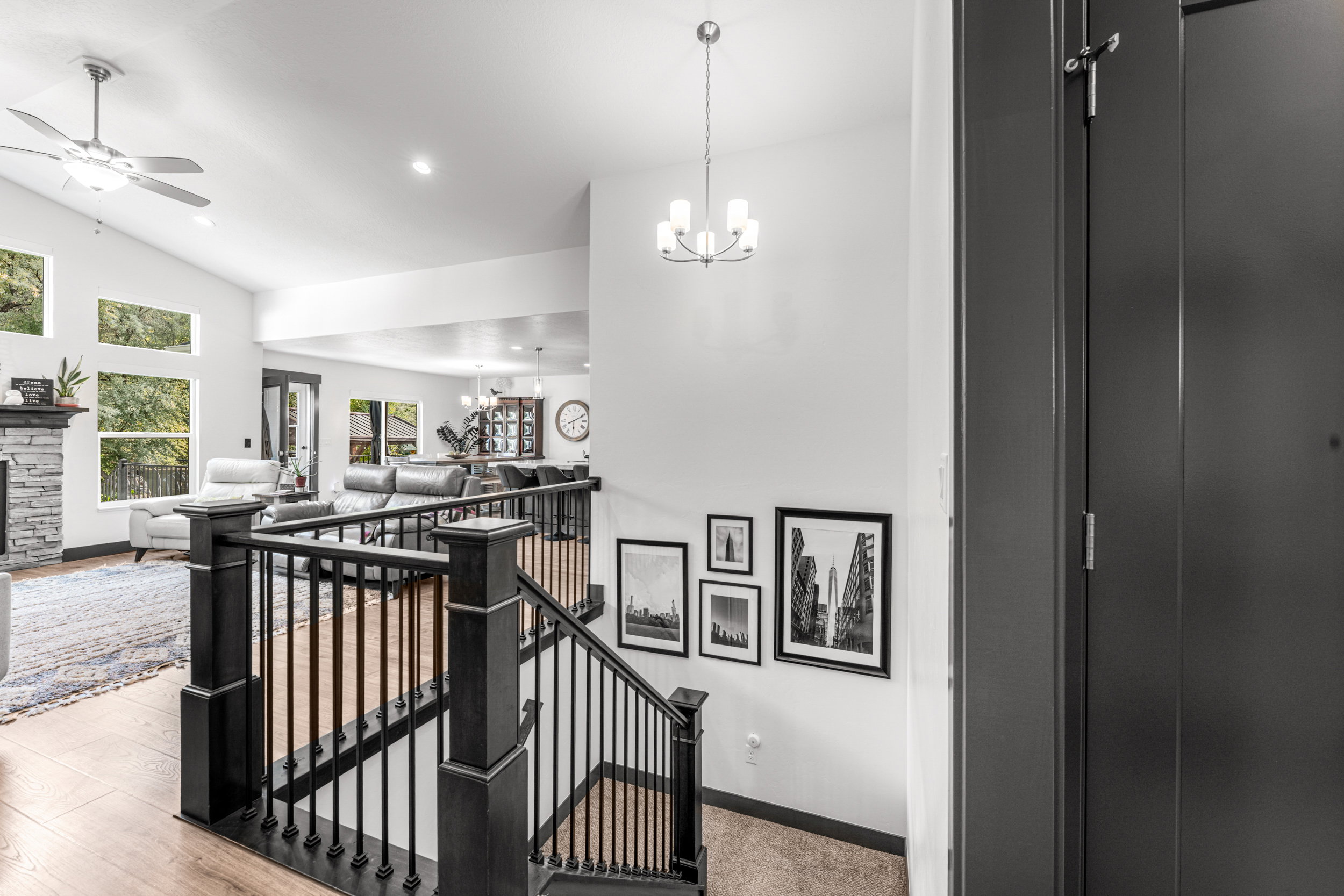 Split-level entry with dark wood-finish staircase and wrought iron balusters