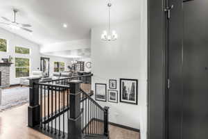 Split-level entry with dark wood-finish staircase and wrought iron balusters
