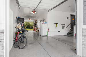 Spacious garage featuring a durable epoxy floor finish, overhead lighting, and interior access to the property