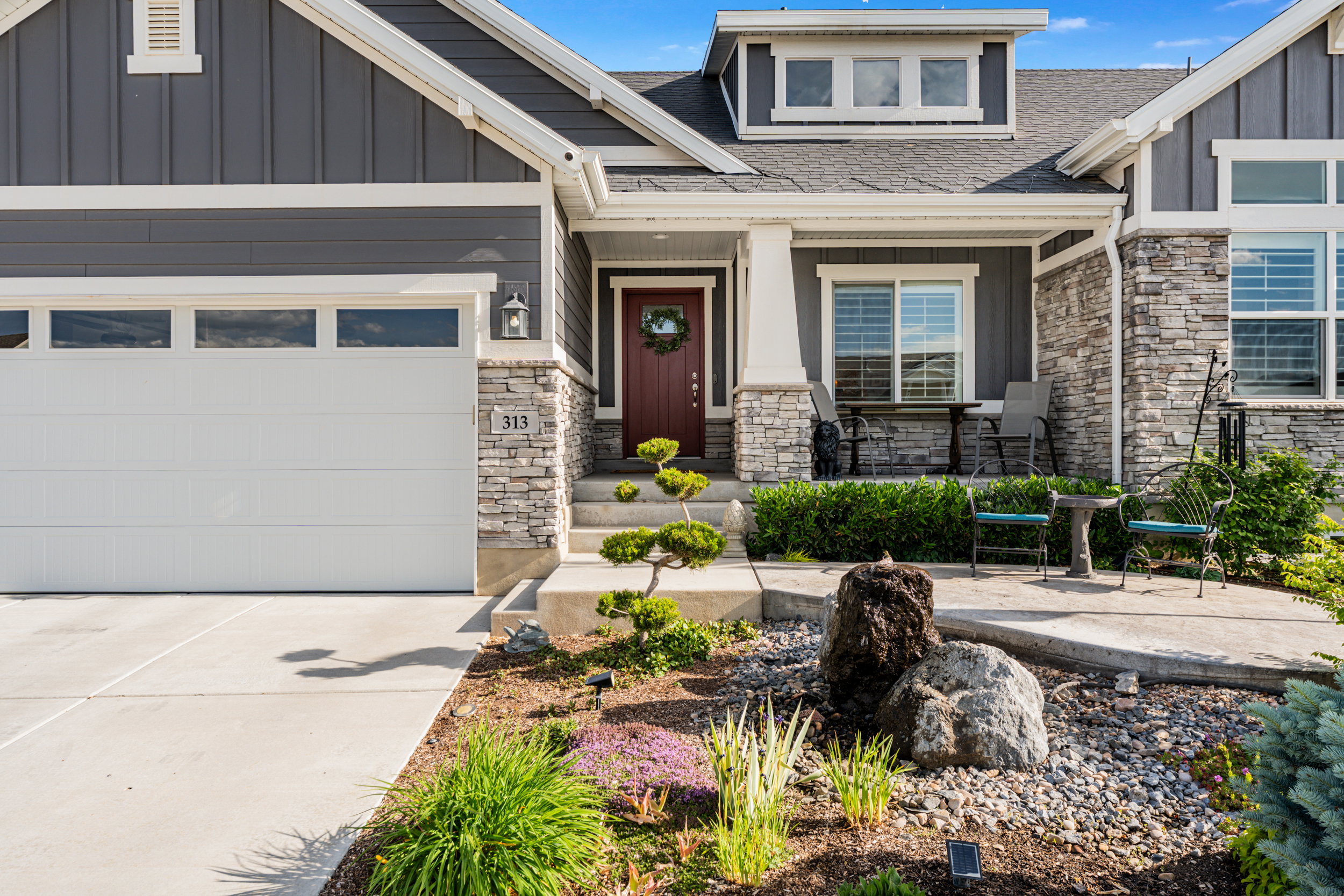 Contemporary gray siding exterior with stone accents