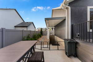 Expansive concrete patio with a covered outdoor area, offering direct access to the lower level