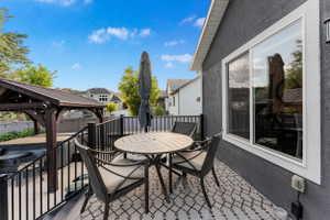 Outdoor patio featuring a dark stucco exterior and a white-framed window