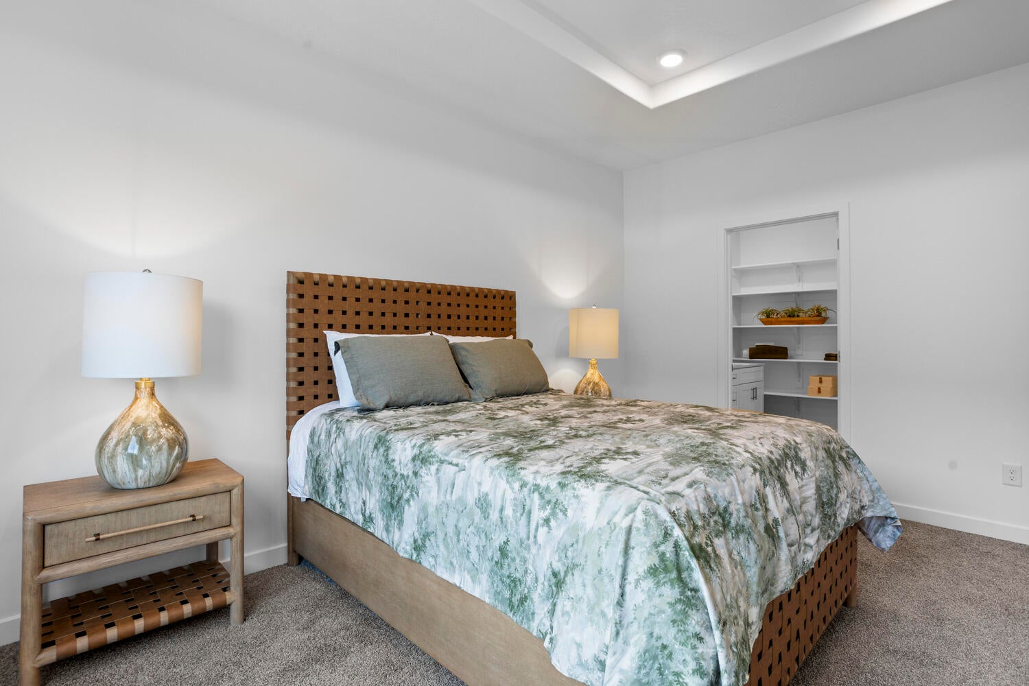 Neutral wall tones, recessed lighting, and tray ceiling detail