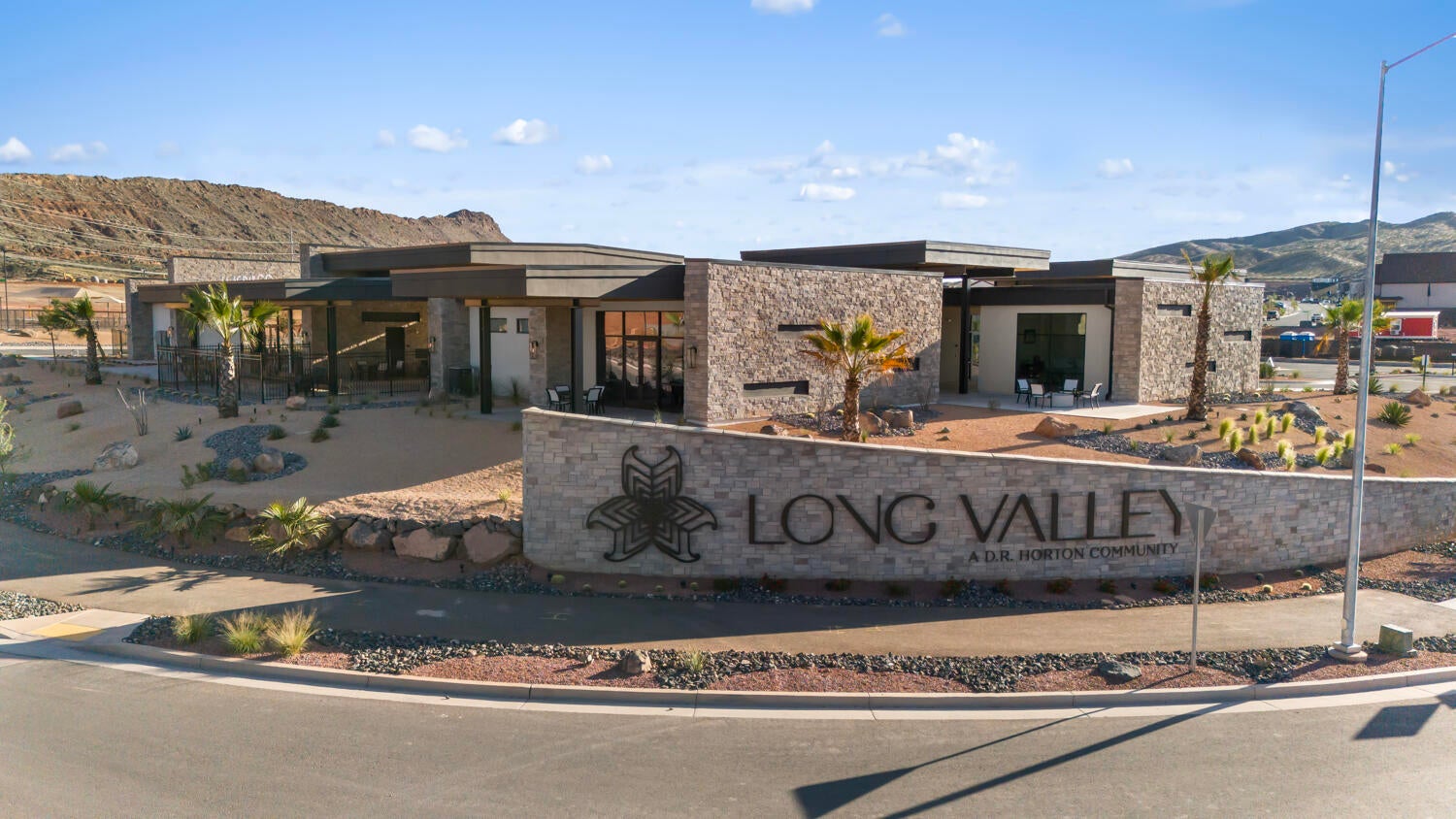 Stone-clad entry monument with integrated signage