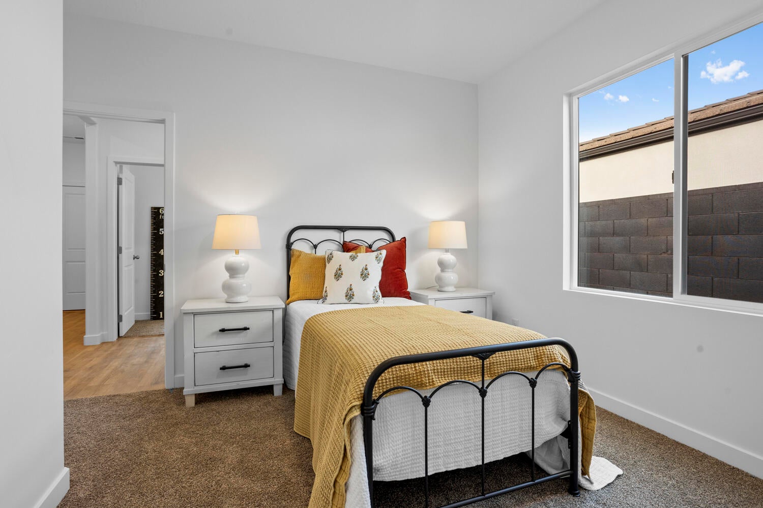 Bedroom featuring neutral-toned carpeting and a double-pane window