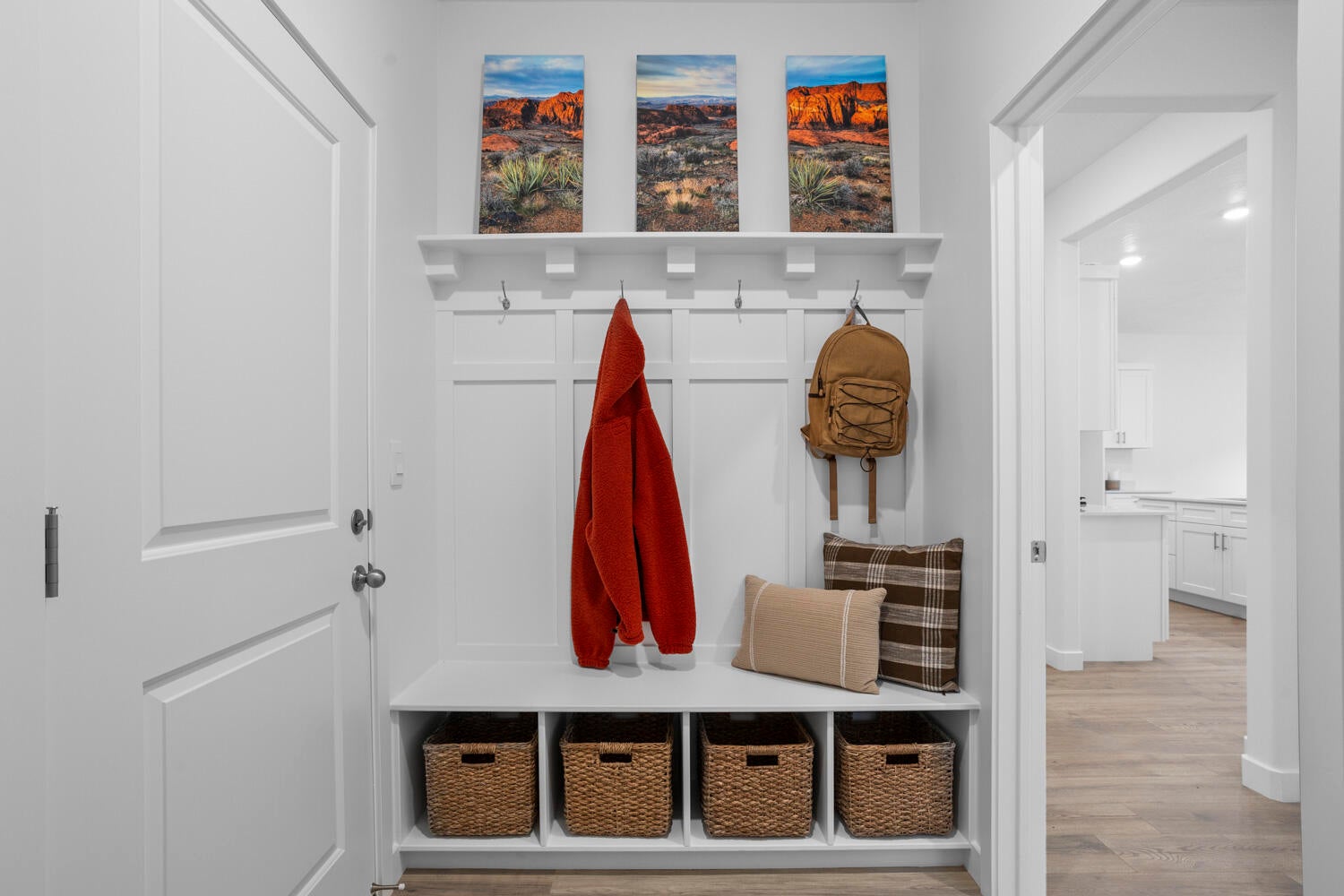 Entryway featuring a built-in bench with storage cubbies and a coat rack