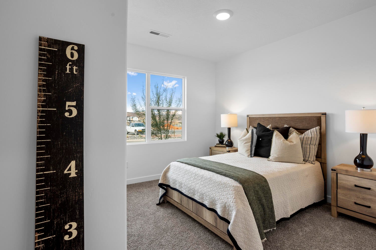 Light-filled room featuring a double window, recessed ceiling lighting, and soft carpet flooring