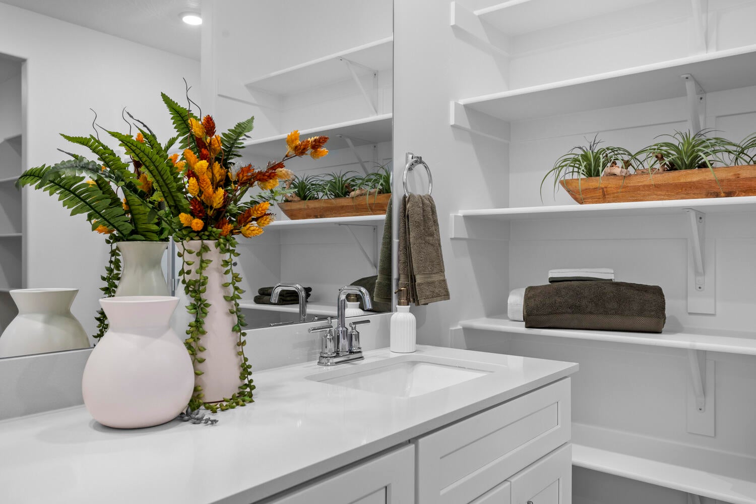 White countertop vanity with an integrated sink and chrome faucet
