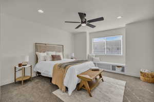 Carpeted bedroom featuring a ceiling fan with integrated lighting, recessed lighting, and a built-in window bench with open shelving