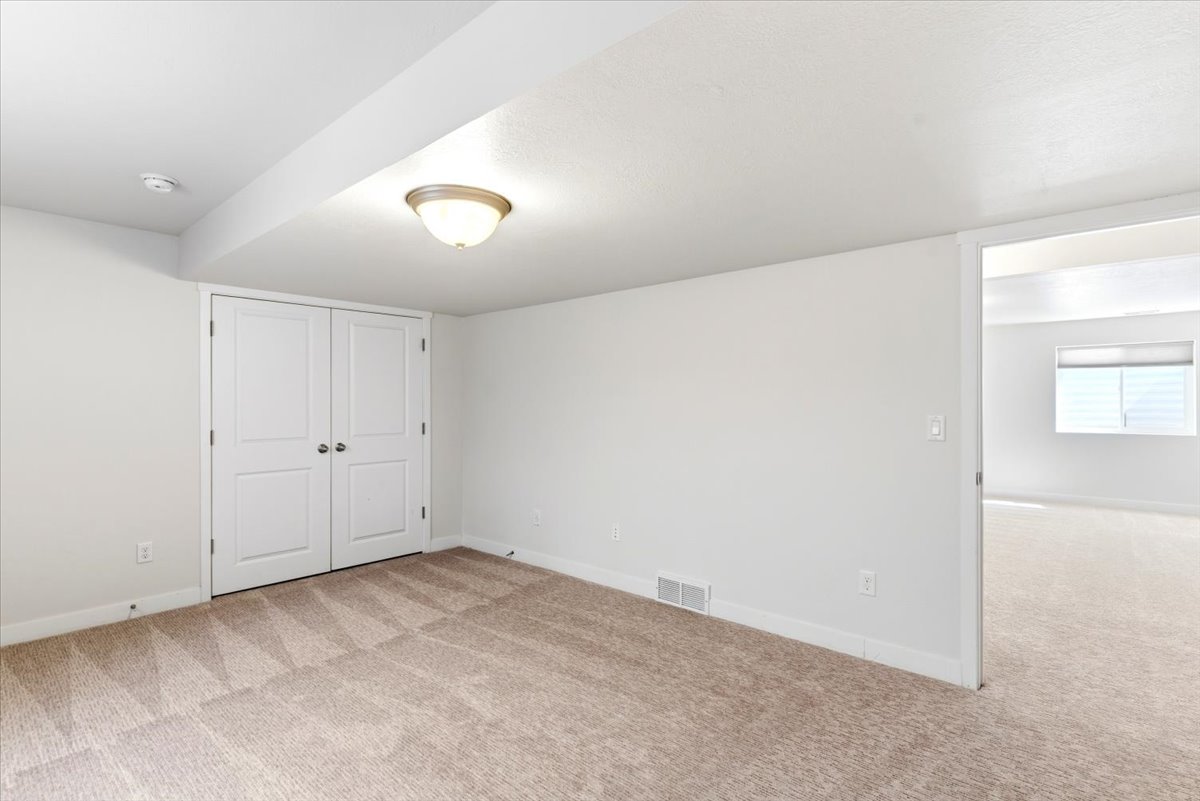 Carpeted interior space featuring white walls and white trim