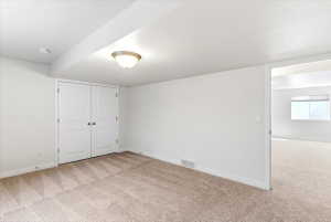 Carpeted interior space featuring white walls and white trim