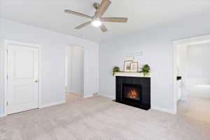 Primary bedroom with fireplace, ceiling fan and en-suite bathroom