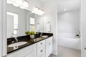 Primary bathroom with dual vanity, granite countertop