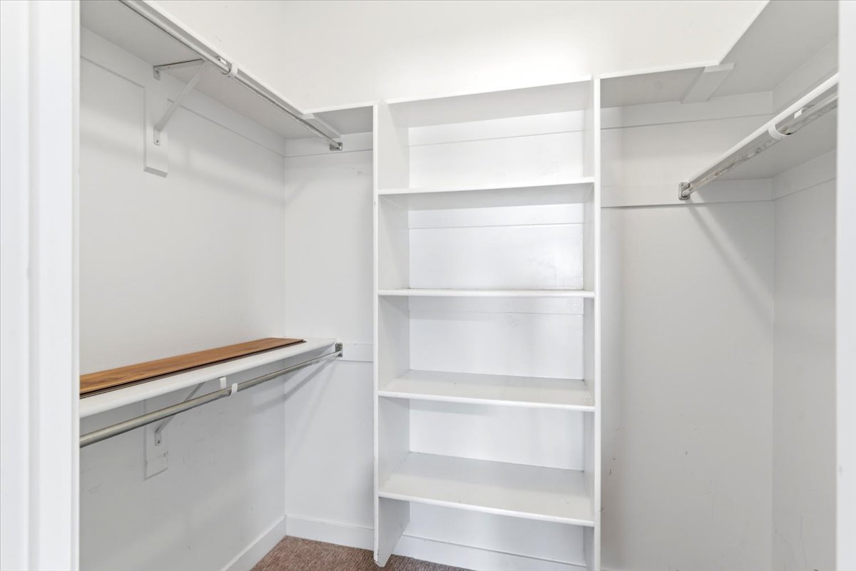 Primary bedroom walk-in closet