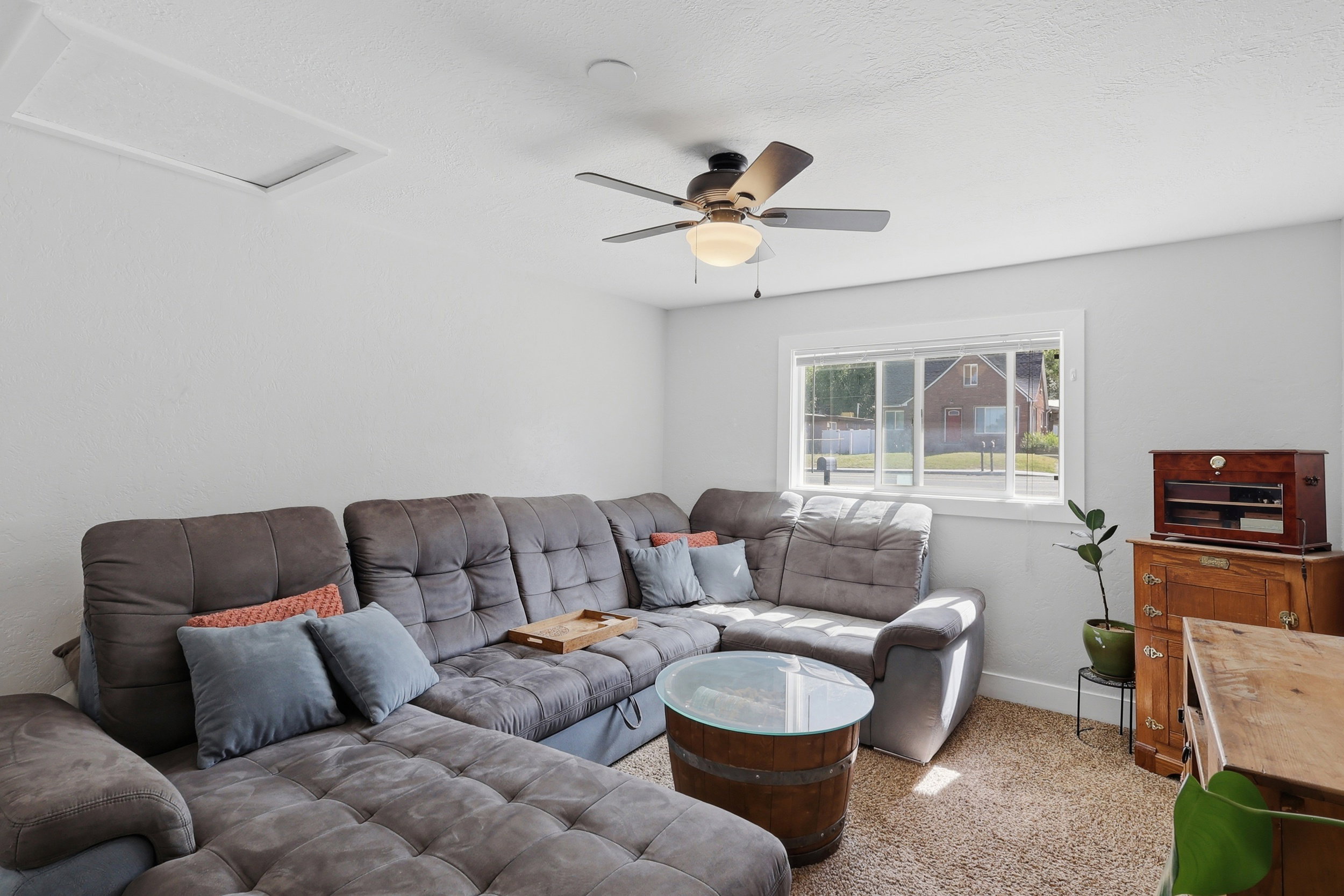 Recessed overhead lighting, ceiling fan with light fixture, carpeted flooring, and a single window with white trim