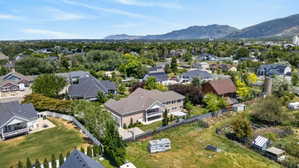 Expansive aerial view showcasing a residential neighborhood with a mountain backdrop