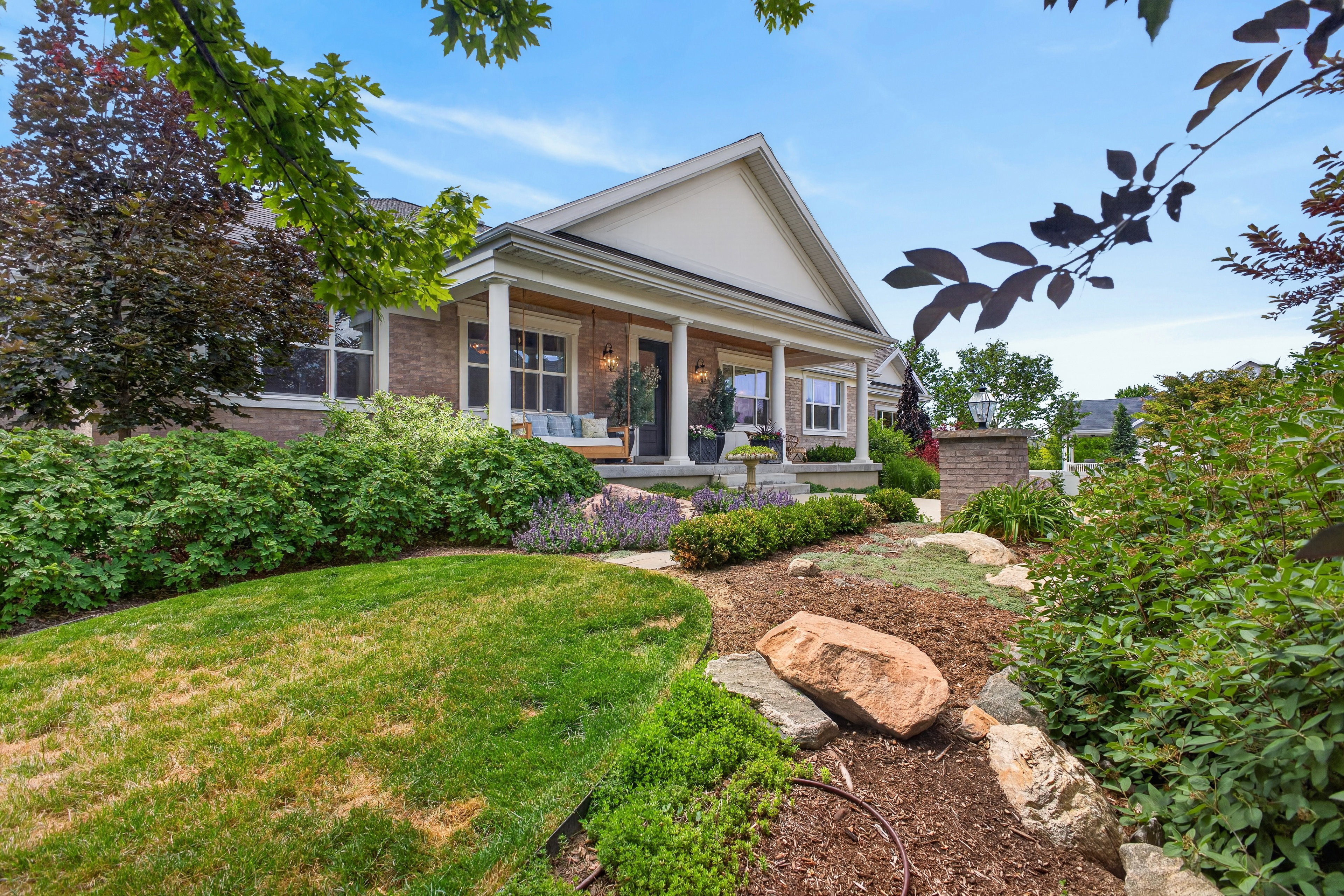 Brick exterior with gabled portico and white columns