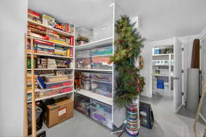 Built-in shelving system with white finishes, offering extensive storage capacity within a dedicated area