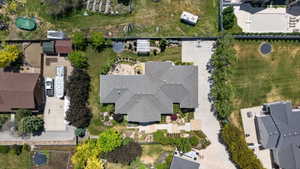 The property features a large main residence with a gabled roofline, extensive paved areas, and mature landscaping