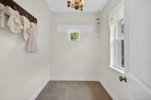 Compact room featuring two windows, neutral wall tones, and a single ceiling fixture