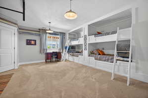 Built-in bunk beds with integrated shelving and wall sconces