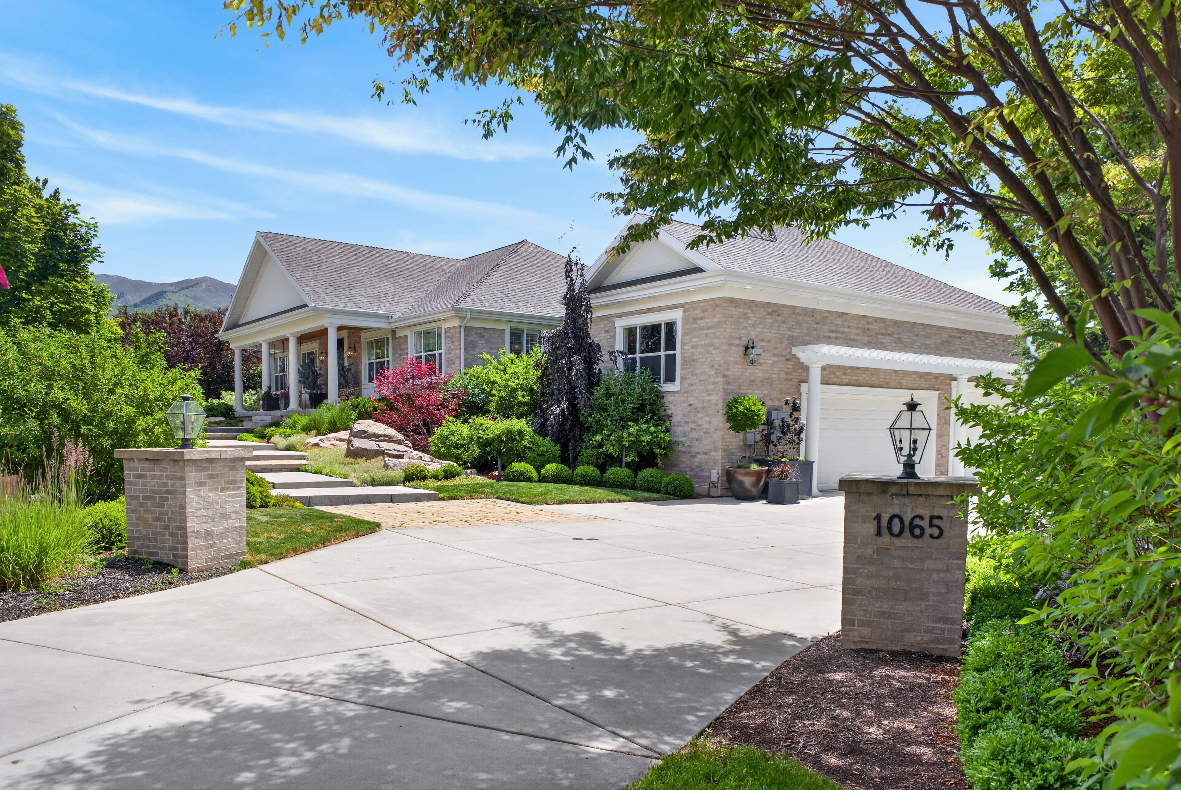 Light brick exterior with a prominent front porch supported by white columns