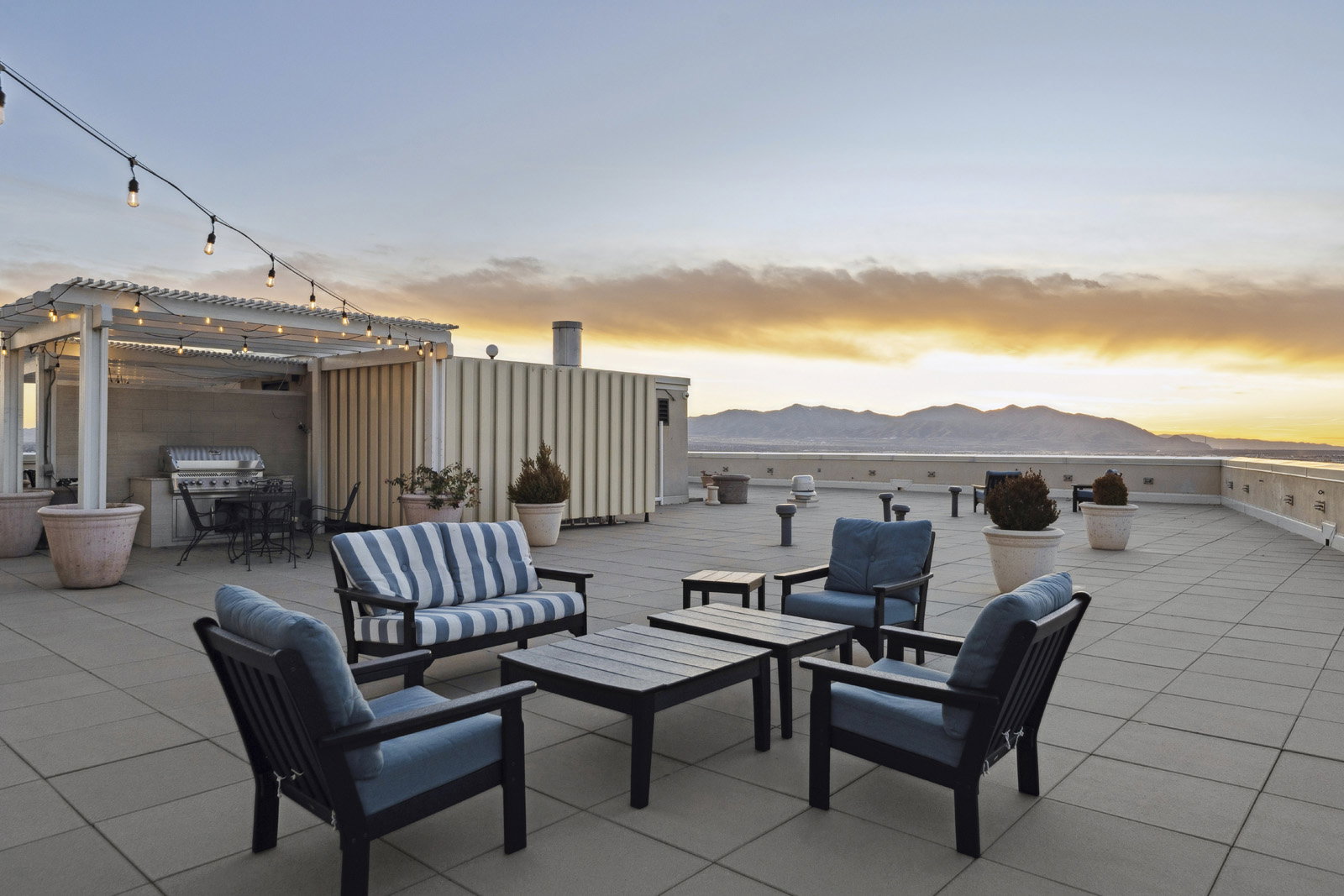 Expansive rooftop deck featuring large format tile flooring and a mountain backdrop