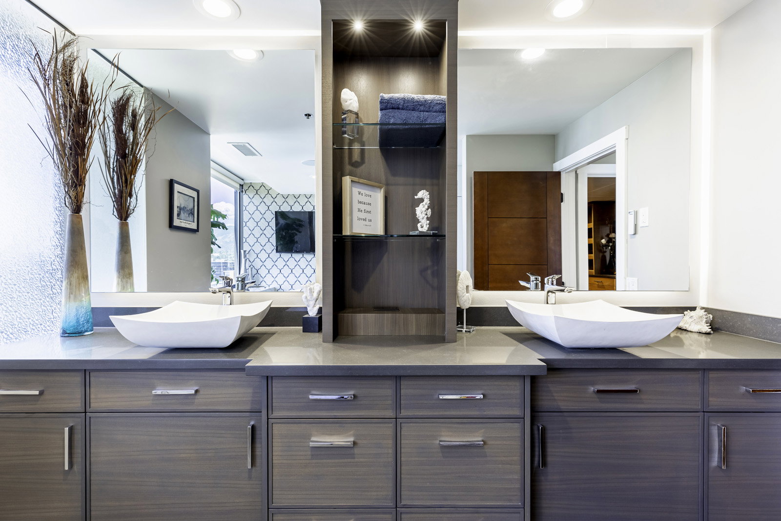 Dual vanity with wood-finish cabinetry, under-mount lighting, and integrated vessel sinks