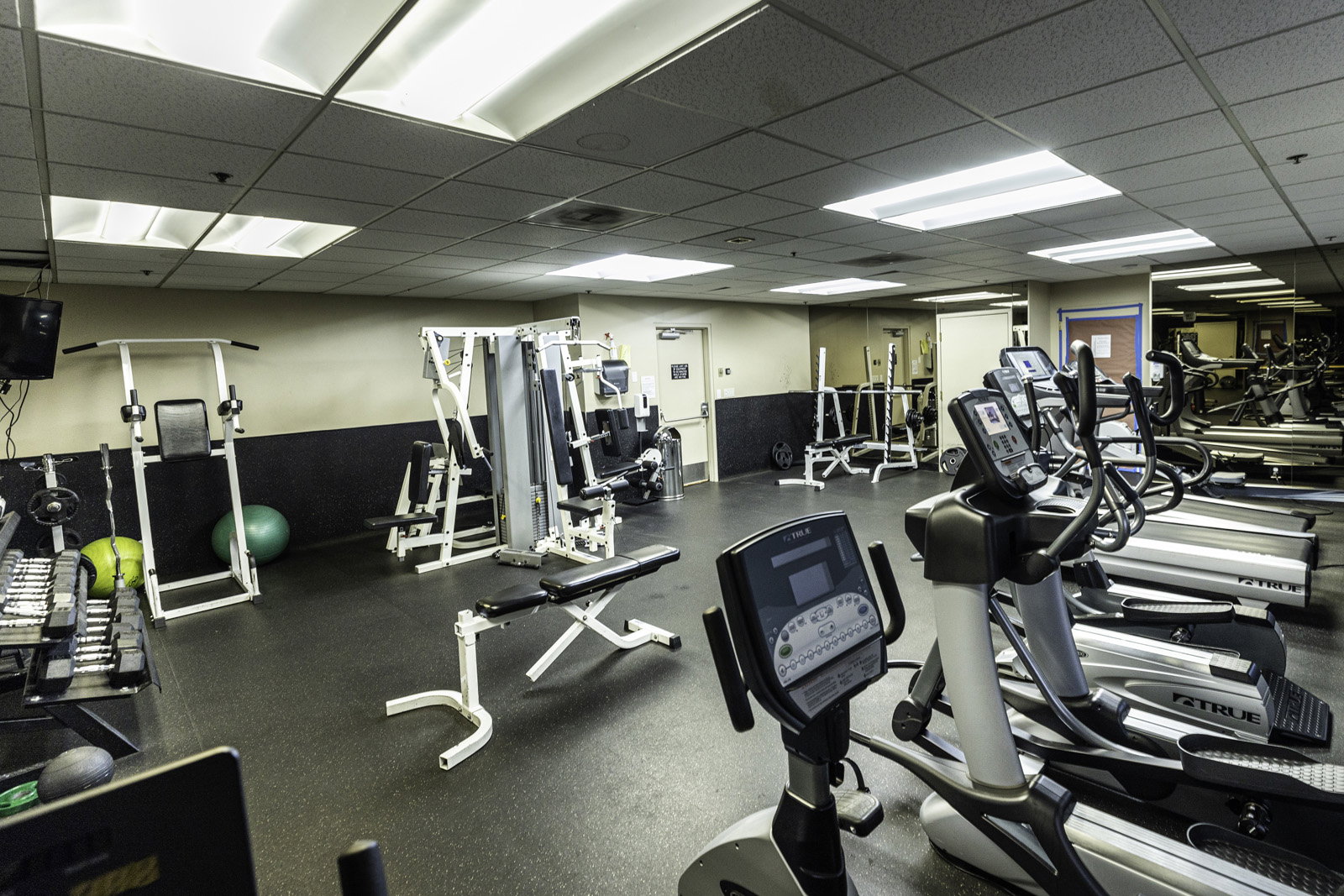 Fitness center featuring dedicated cardio and weight training zones