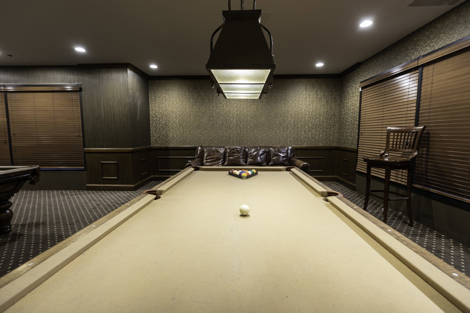 Recreation room featuring a billiards table with a distinctive overhead light fixture