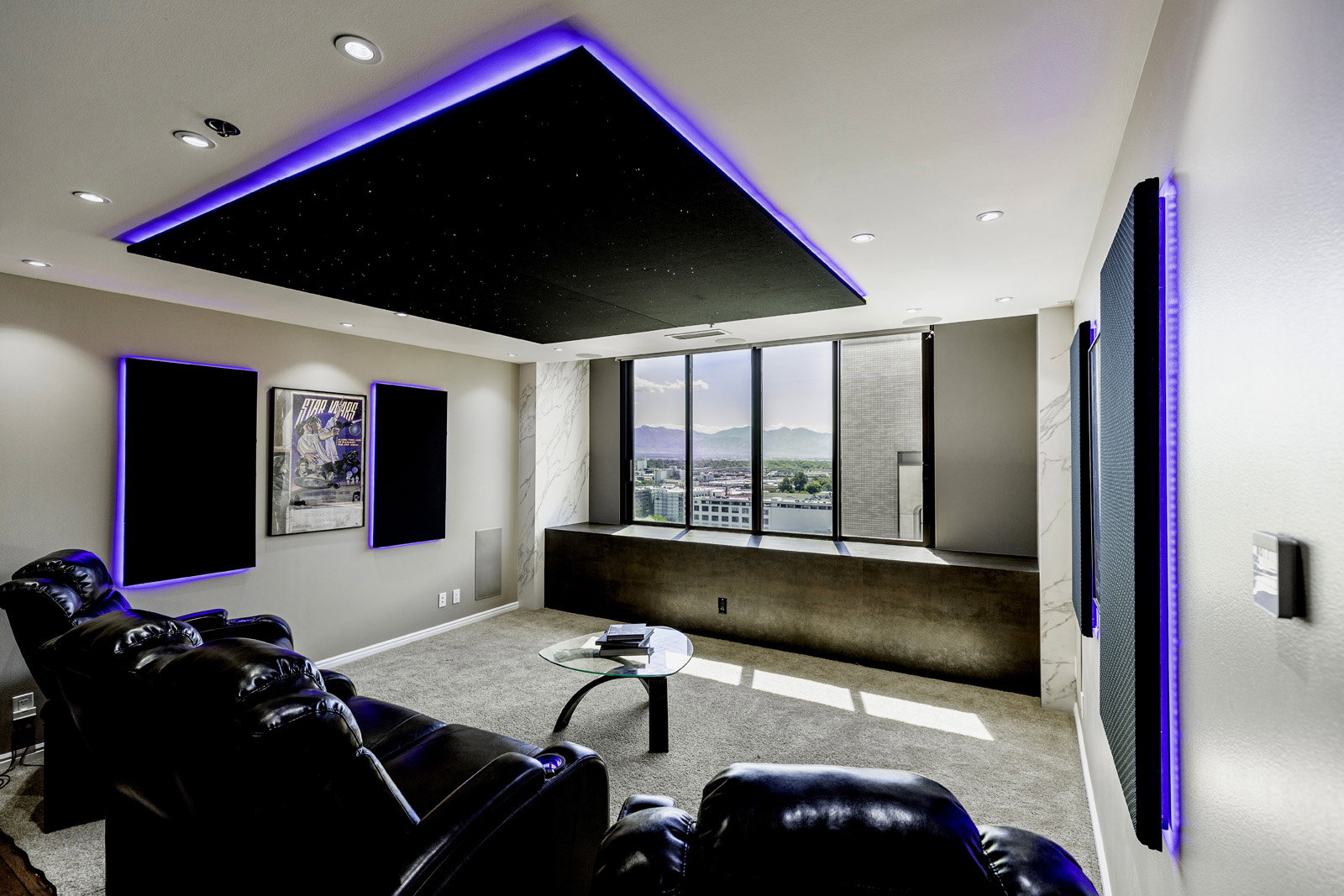 Media room featuring a recessed ceiling with perimeter lighting and integrated downlights