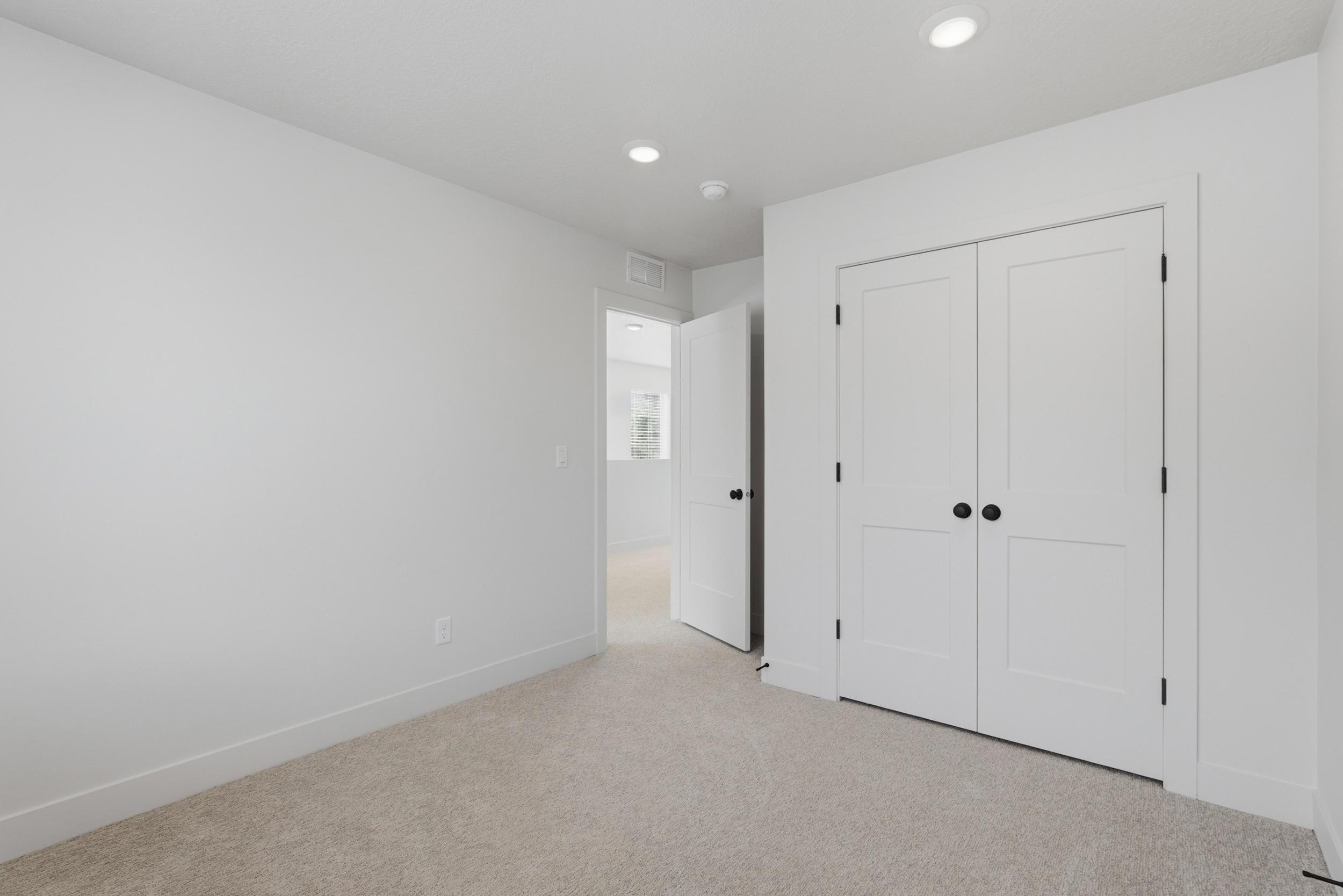 Light-colored carpeting complementing white walls and baseboards