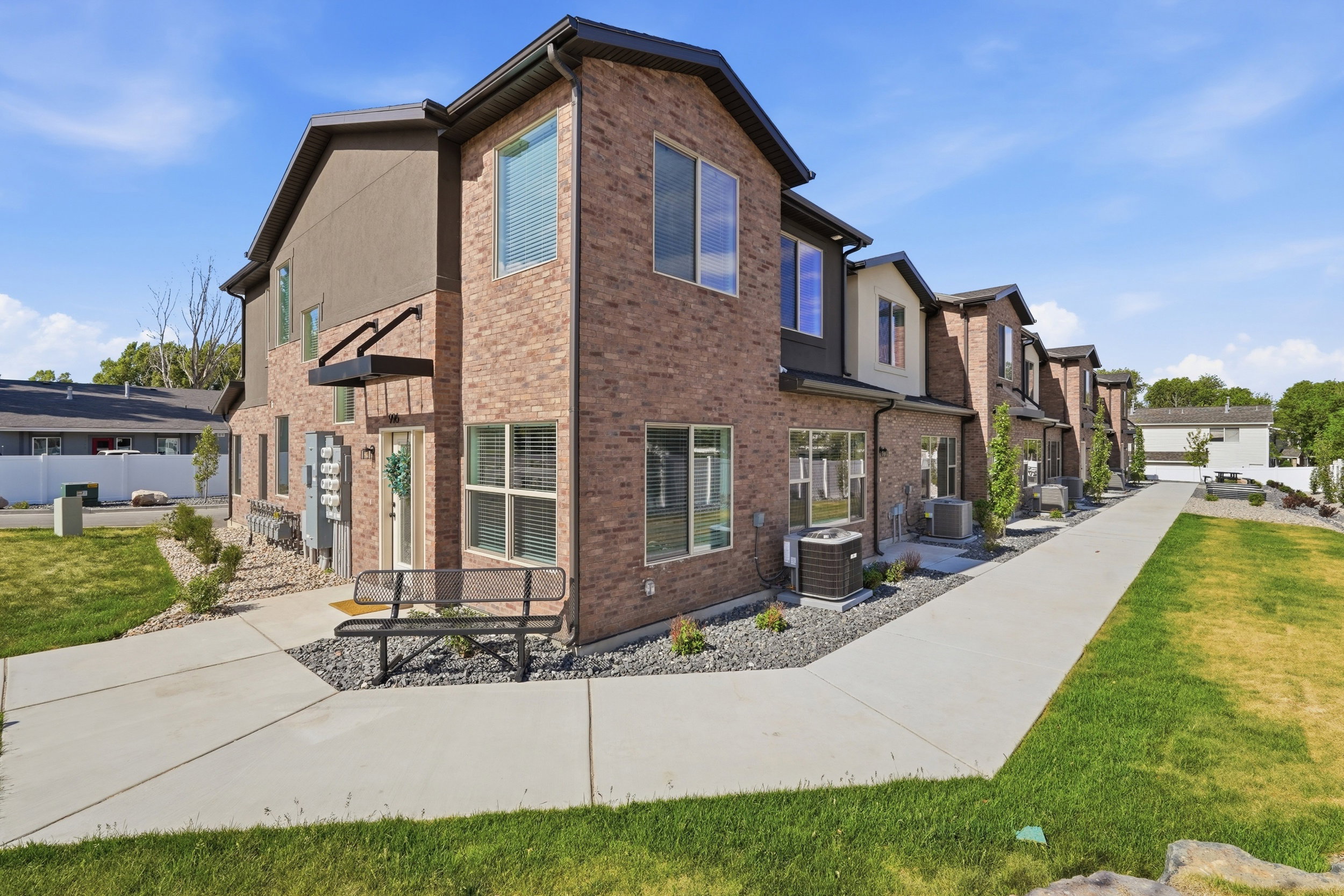 Contemporary townhome exterior featuring brick and stucco siding