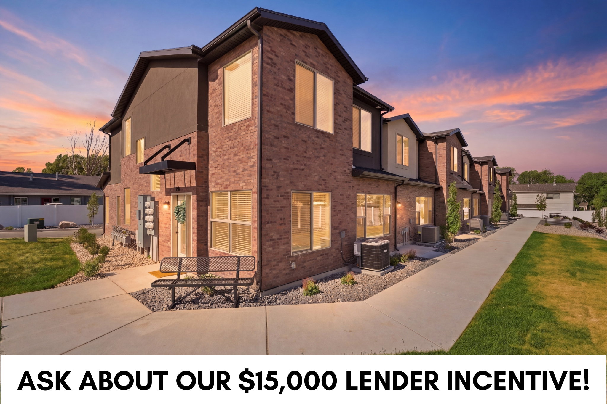 Modern townhome-style residences featuring brick and dark siding exteriors, multiple windows, and individual entryways