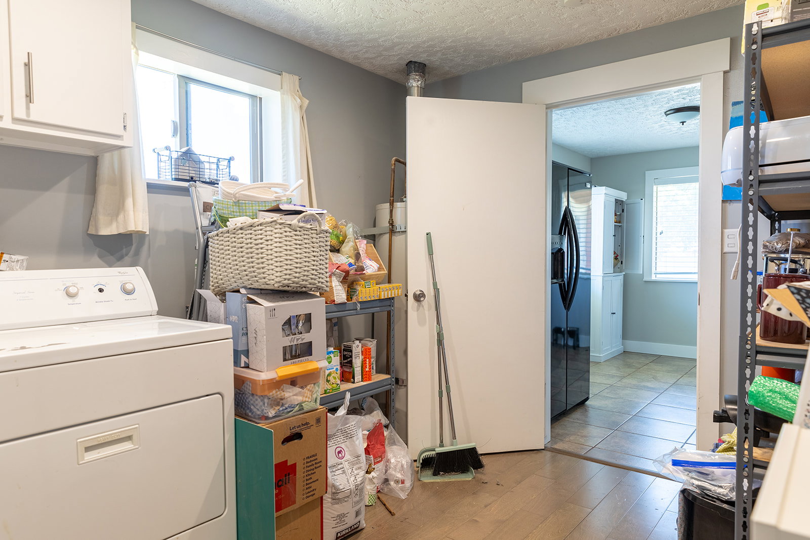 Laundry area featuring light wood-finish flooring and a single-pane window