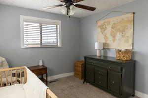 Room featuring a window with horizontal blinds, a ceiling fan with light fixture, and neutral gray wall paint