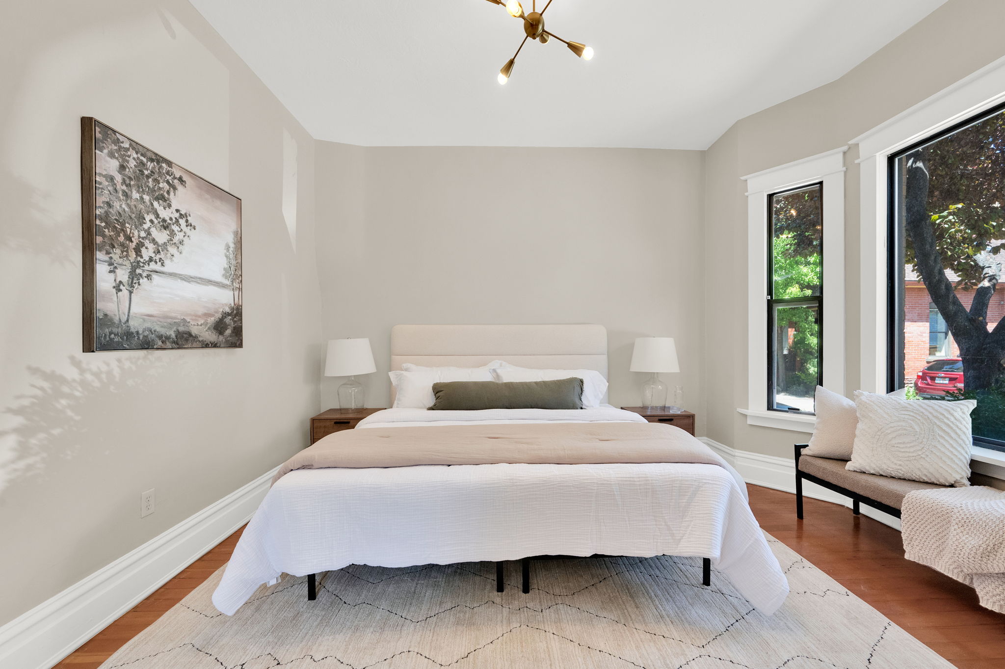 Hardwood flooring complements a decorative ceiling light fixture